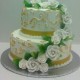 Two Tier Butter Cream With Hand Painted Gold Scroll High Lights With Elegant ,White Cascading Roses. The Top And Bottom Tiers Cumulate in Beautiful White Bouquets &#160;